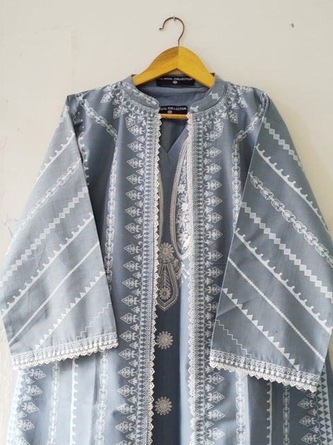 Gray embroidered shirt on a hanger against a white wall