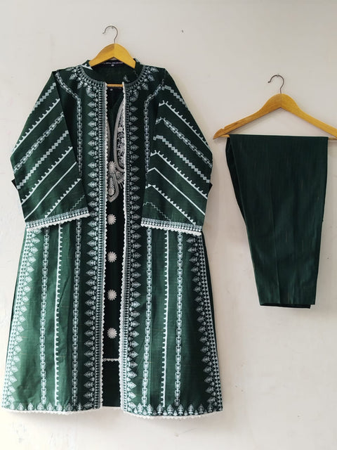 Green embraided patterned coat and black trouser on hangers against a white background