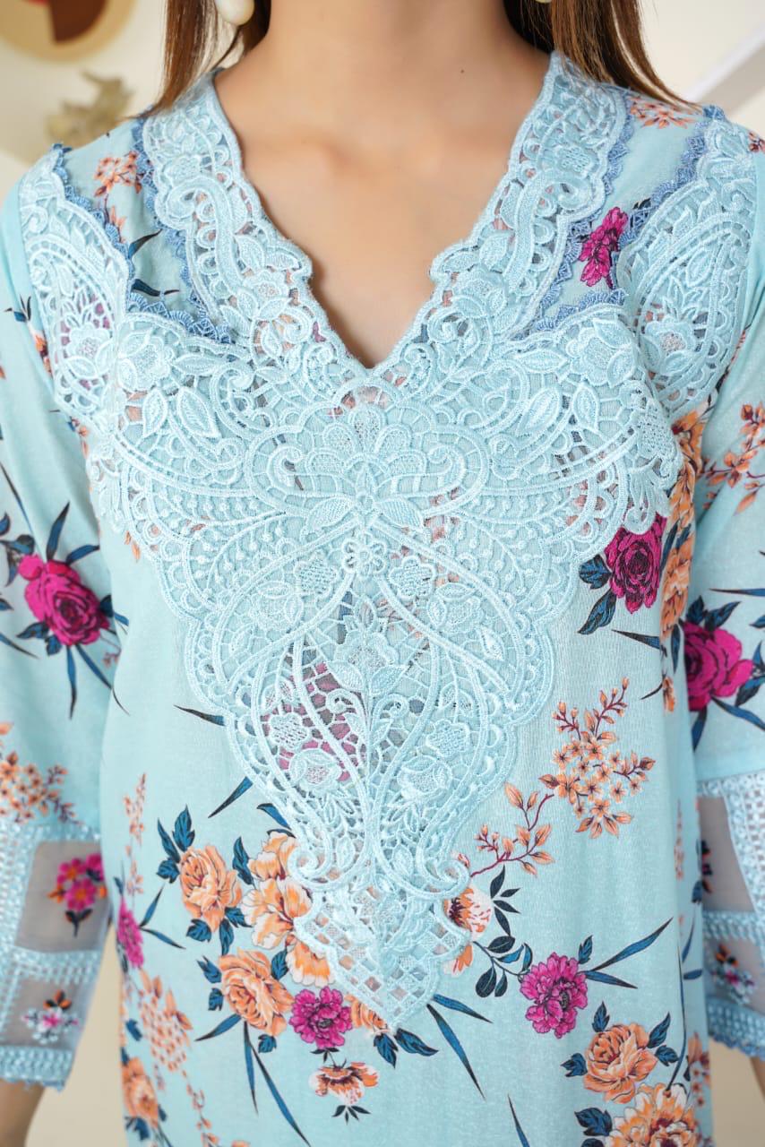 Light blue lace top with floral patterns on a mannequin