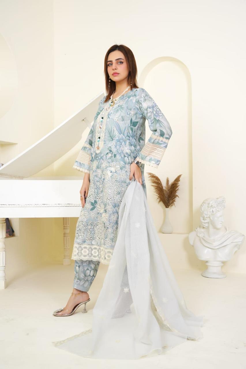 Woman in a floral dress holding a white dupatta in a decorative setting