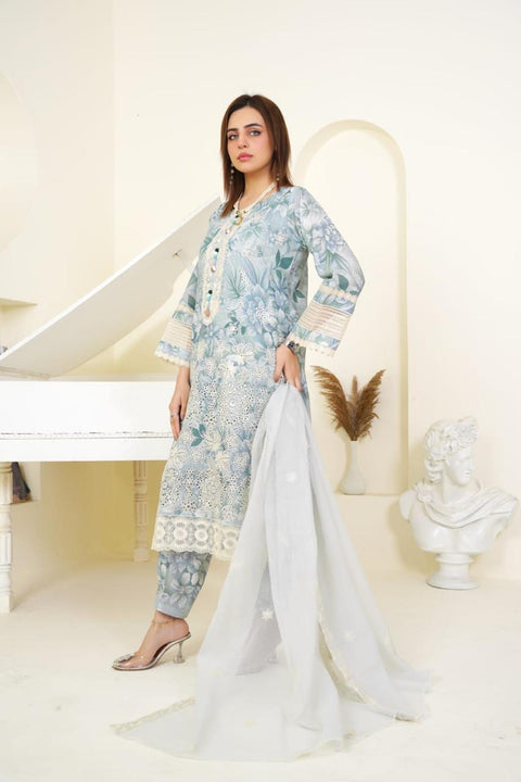 Woman in a floral dress holding a white dupatta in a decorative setting