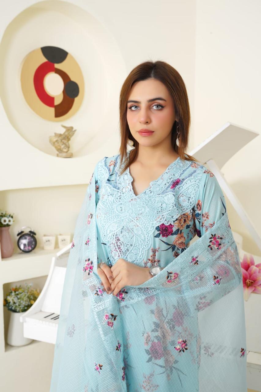 Woman wearing a light blue floral outfit in an indoor setting