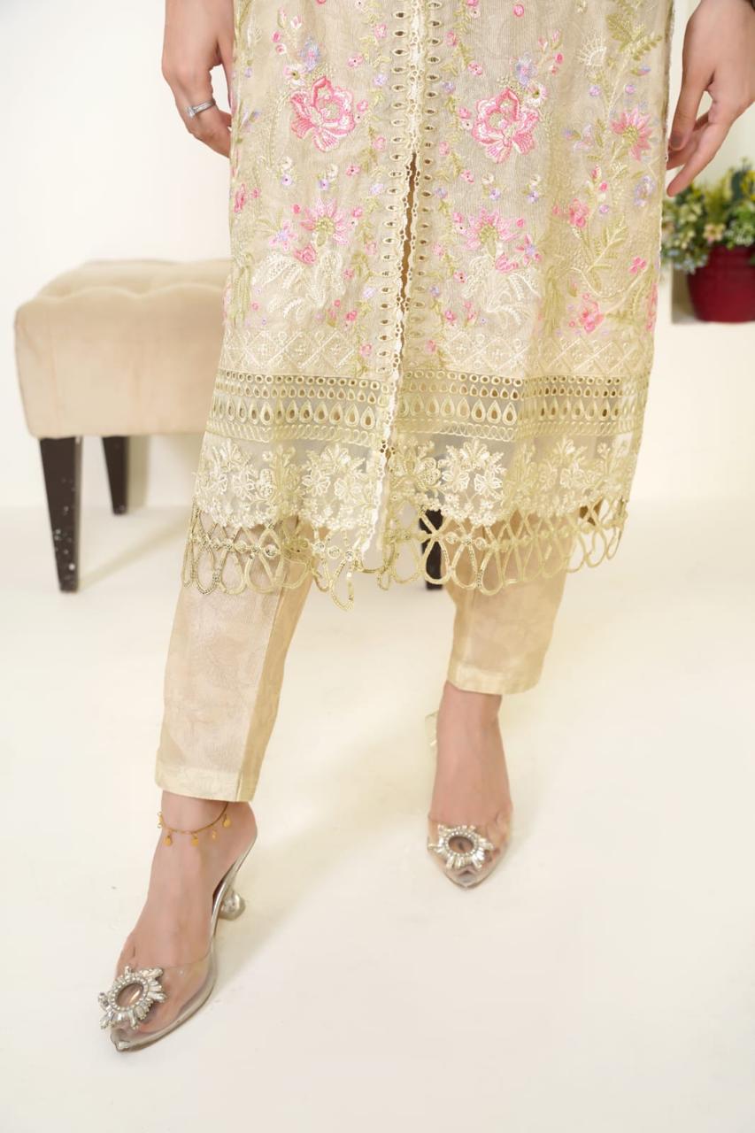 Beige embroidered outfit with floral patterns on a white background