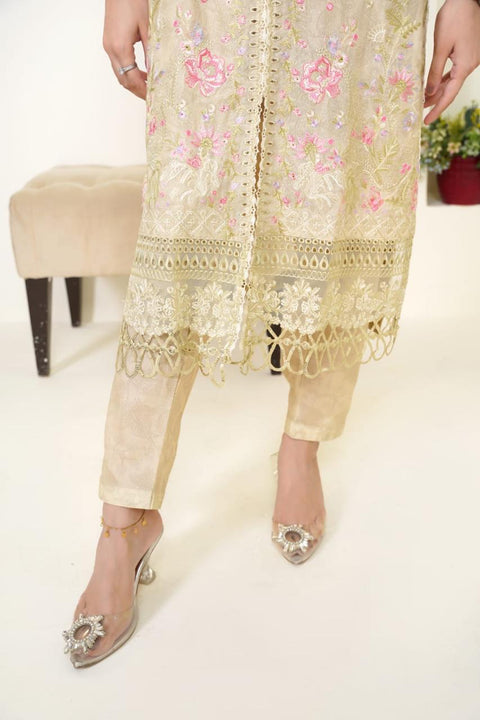 Beige embroidered outfit with floral patterns on a white background